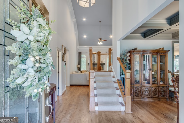 interior space with beam ceiling, hardwood / wood-style floors, coffered ceiling, a healthy amount of sunlight, and ceiling fan