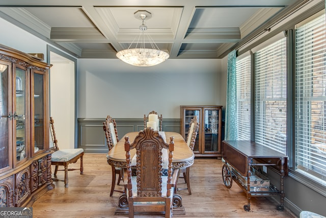 dining room with hardwood / wood-style floors, crown molding, and coffered ceiling