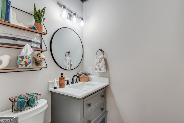 bathroom featuring vanity and toilet