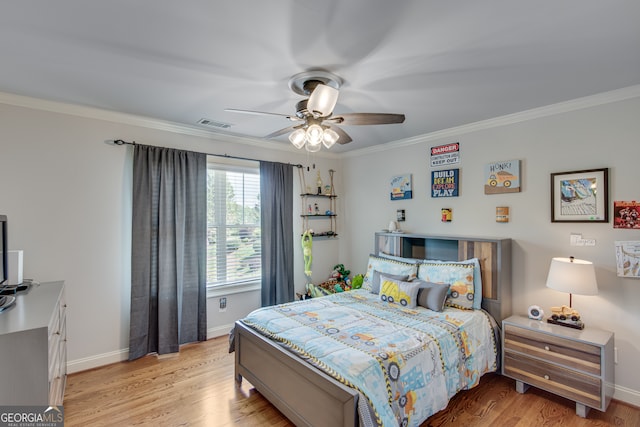 bedroom featuring ceiling fan, crown molding, and light hardwood / wood-style flooring