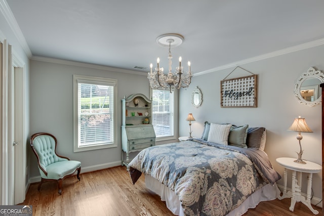 bedroom featuring a notable chandelier, light hardwood / wood-style floors, and ornamental molding