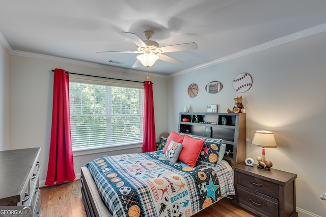 bedroom with ceiling fan, crown molding, and hardwood / wood-style flooring