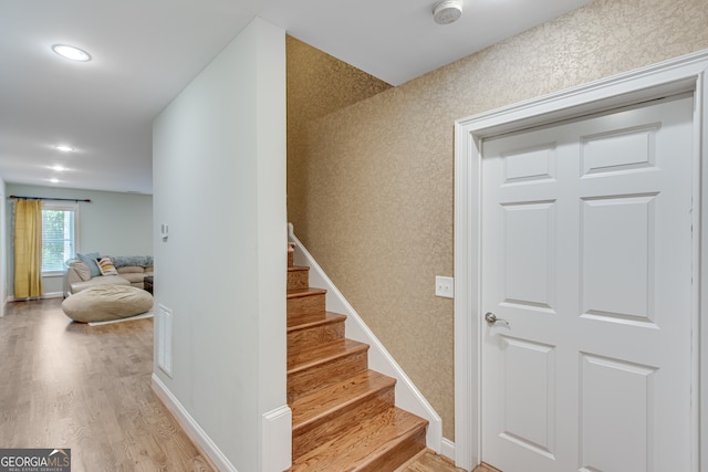 staircase with wood-type flooring