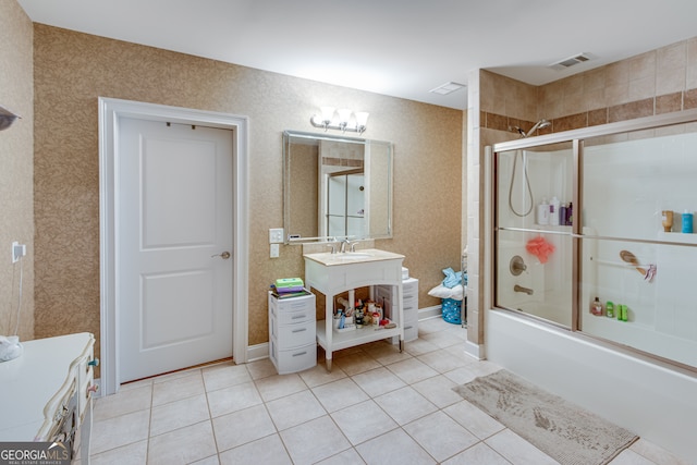 bathroom with combined bath / shower with glass door, tile patterned flooring, and vanity