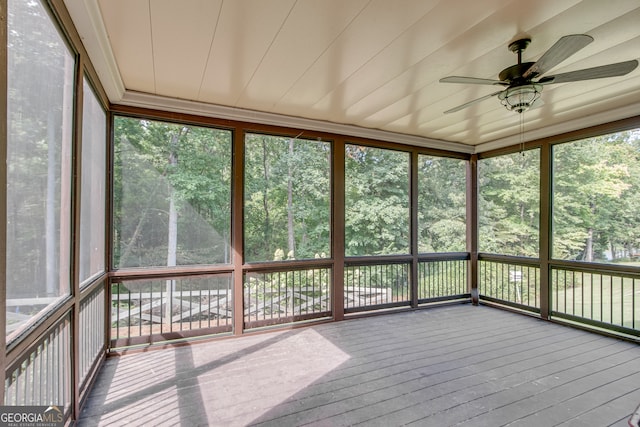 unfurnished sunroom with ceiling fan