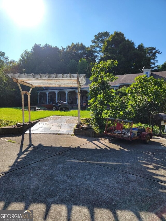 view of car parking featuring a lawn