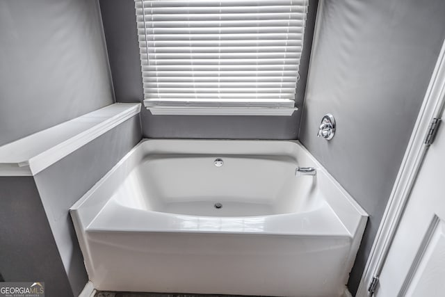 bathroom with a tub to relax in