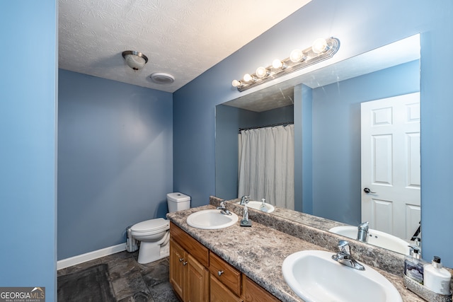 bathroom featuring tile patterned flooring, toilet, double vanity, and a textured ceiling