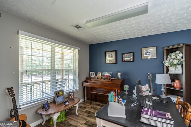 home office with a textured ceiling and wood-type flooring