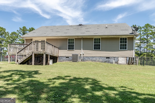 back of house with a wooden deck, a yard, and central AC