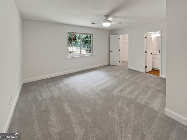 carpeted empty room with ceiling fan