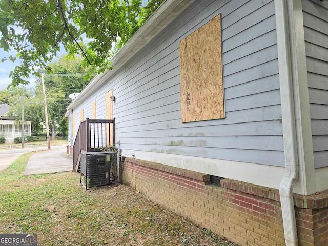 view of side of home featuring central air condition unit and a patio area