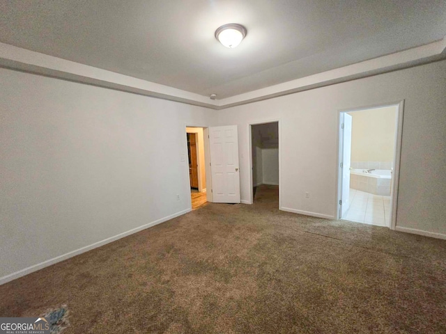 unfurnished bedroom with carpet flooring and ensuite bathroom