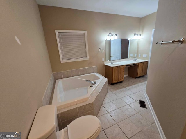 bathroom with tile patterned floors, vanity, tiled tub, and toilet