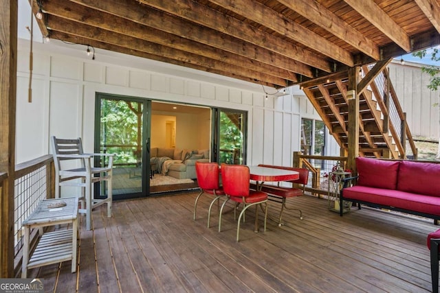 wooden terrace with an outdoor hangout area