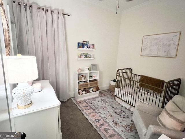 carpeted bedroom featuring a nursery area, ornamental molding, and baseboards