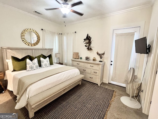 bedroom featuring ceiling fan, dark carpet, visible vents, and crown molding