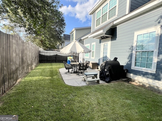 view of yard with a patio area and a fenced backyard