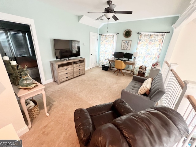 living area with light carpet, lofted ceiling, a ceiling fan, and baseboards