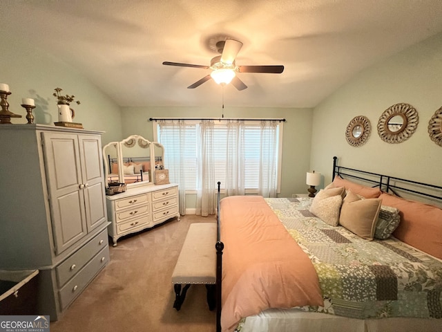 bedroom featuring a ceiling fan, carpet flooring, and vaulted ceiling