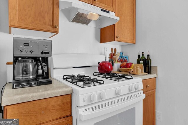 kitchen with white range with gas stovetop