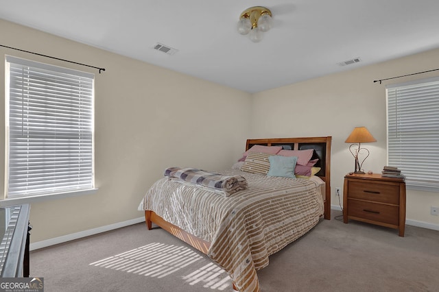 bedroom featuring light carpet