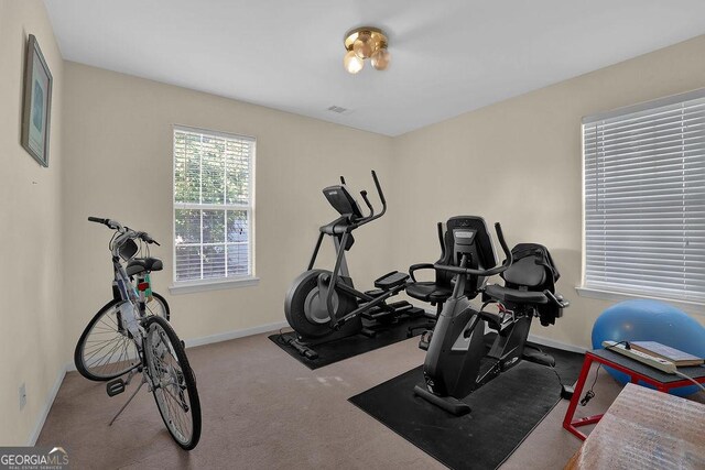 workout area featuring light colored carpet