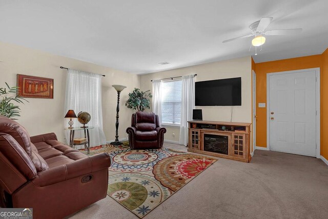 living room with ceiling fan and light colored carpet