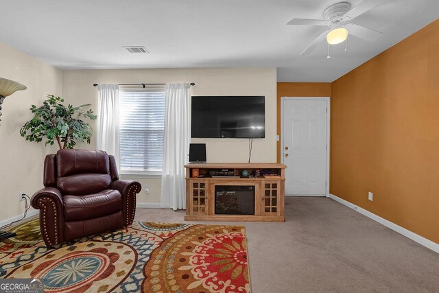 living room with ceiling fan and light colored carpet