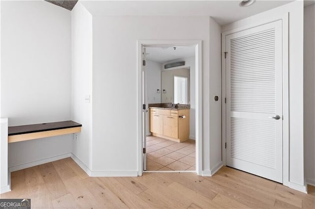 corridor with light hardwood / wood-style floors