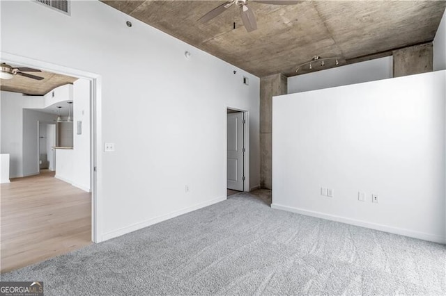 empty room with light carpet and ceiling fan