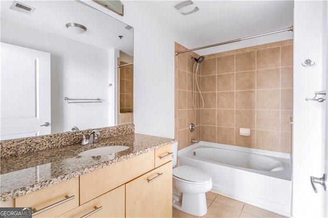 full bathroom with tile patterned flooring, vanity, toilet, and tiled shower / bath