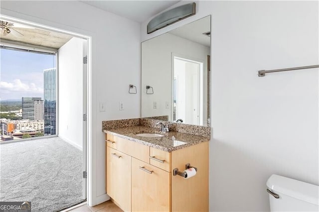 bathroom featuring vanity and toilet