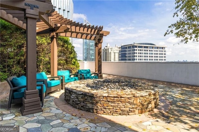 view of patio with a pergola and a fire pit