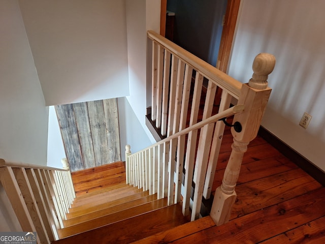 stairs featuring hardwood / wood-style flooring