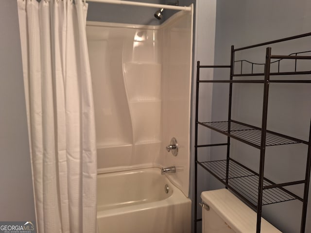 bathroom with shower / tub combo with curtain and toilet