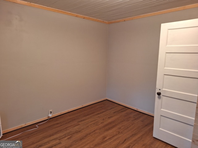 spare room featuring hardwood / wood-style flooring and crown molding