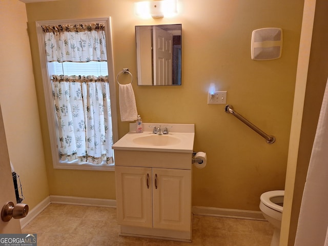 bathroom featuring vanity, toilet, and tile patterned floors