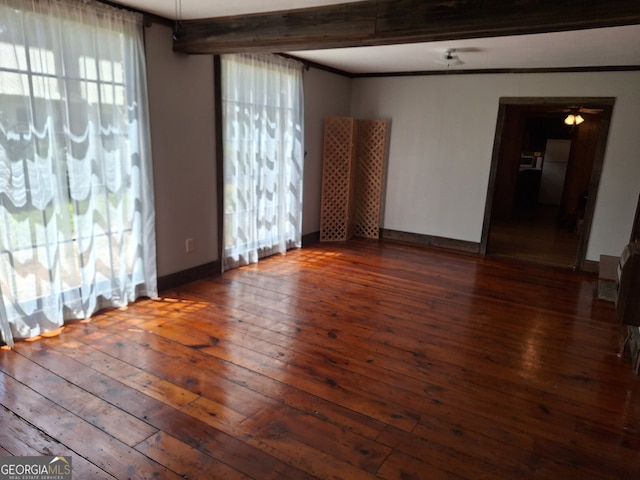 spare room featuring beam ceiling, crown molding, and dark hardwood / wood-style flooring