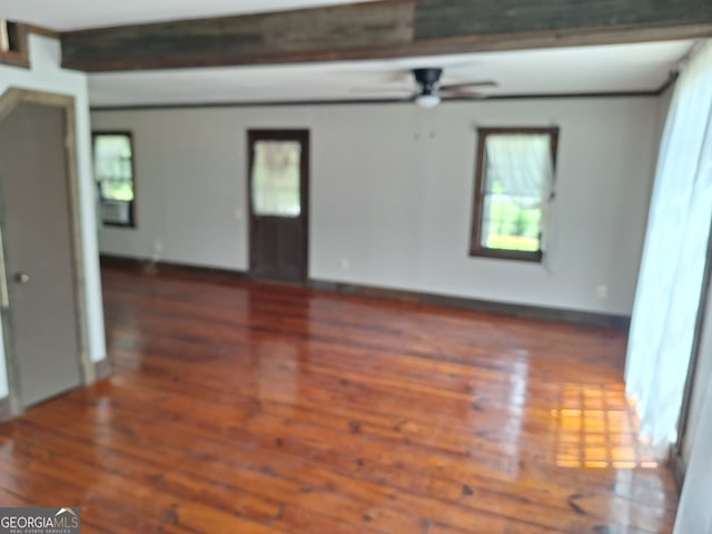 unfurnished room featuring ceiling fan, beamed ceiling, and dark hardwood / wood-style floors