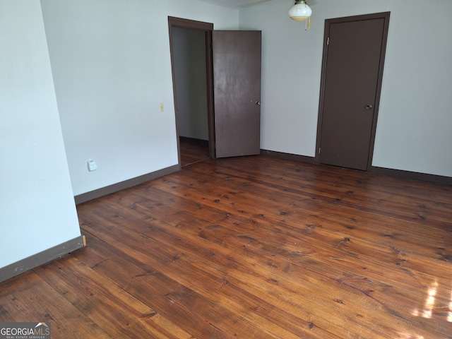 unfurnished room featuring dark hardwood / wood-style floors