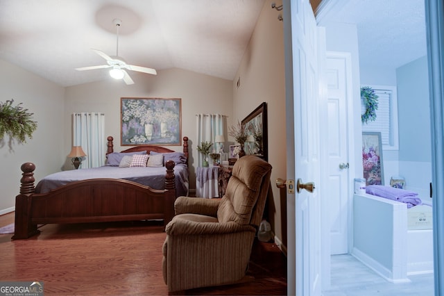 bedroom with ceiling fan, vaulted ceiling, and wood-type flooring