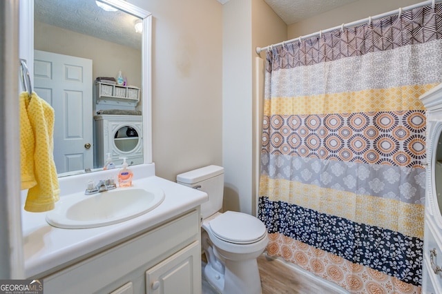 bathroom featuring a textured ceiling, toilet, hardwood / wood-style flooring, and vanity