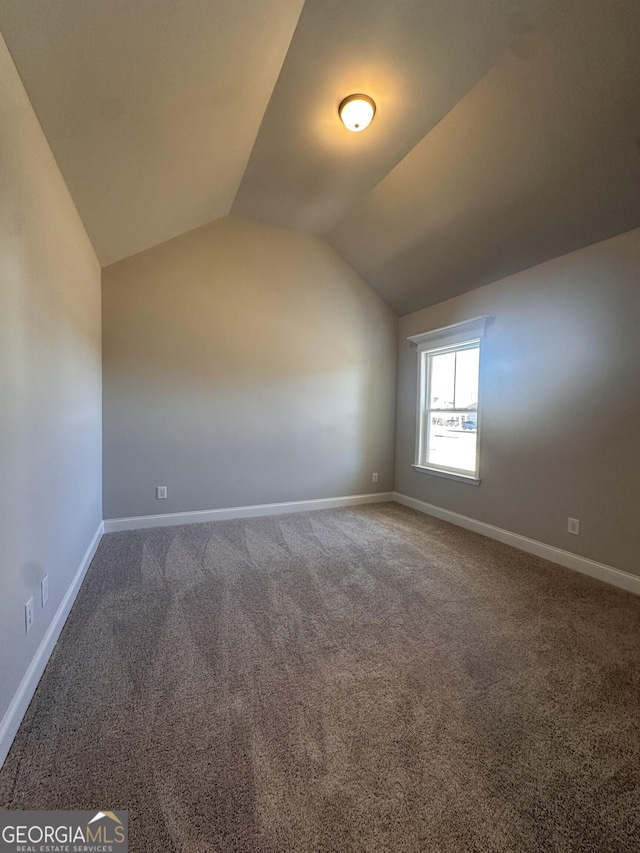 additional living space with lofted ceiling and carpet floors