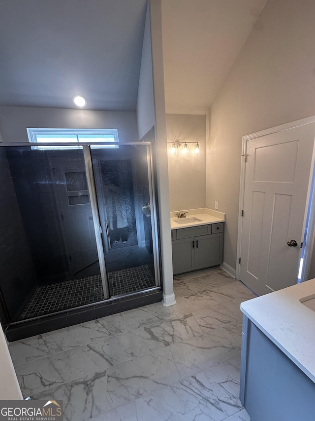 bathroom featuring an enclosed shower and vanity