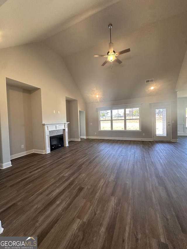 unfurnished living room with ceiling fan, vaulted ceiling, and dark hardwood / wood-style floors