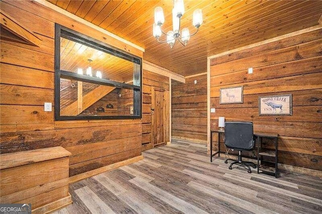 office with hardwood / wood-style flooring, wood ceiling, wooden walls, and a chandelier