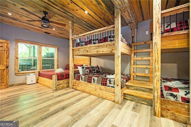 bedroom with ceiling fan, light hardwood / wood-style floors, and wood ceiling