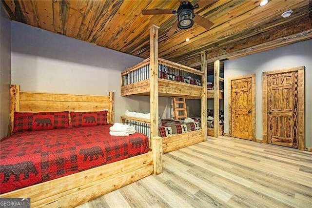 bedroom featuring ceiling fan, light wood-type flooring, and wooden ceiling