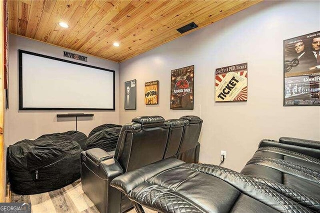 home theater with light hardwood / wood-style flooring and wooden ceiling